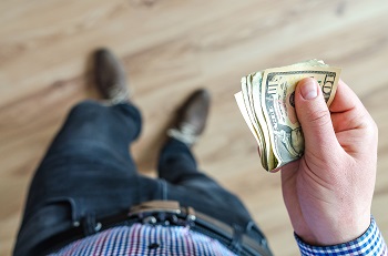man holding money image - life insurance for marijuana users