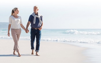 mature couple on beach - annuities