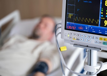 man in hospital bed image